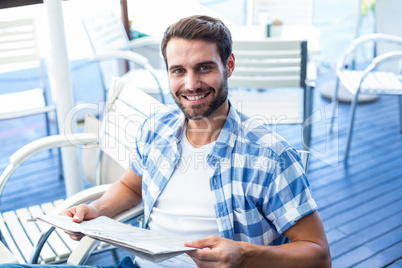 Young man reading the newspapers