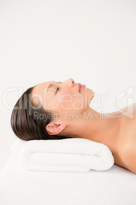 Woman lying on massage table at spa