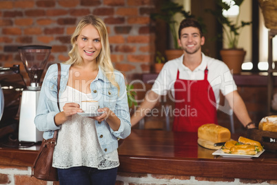 Smiling customer holding a cup of coffee Smiling customer holding a cup of coffee