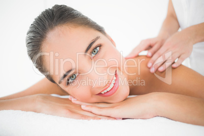 Attractive woman receiving back massage at spa center