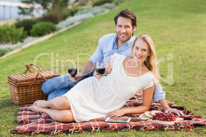 Cute couple on date holding red wine glasses