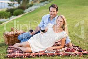 Cute couple on date holding red wine glasses