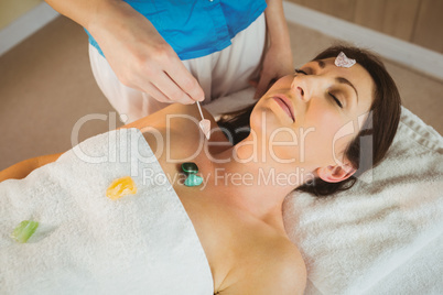 Young woman at crystal healing session