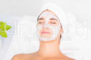 Attractive woman having white cream on her face