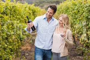 Happy couple looking at wine bottle