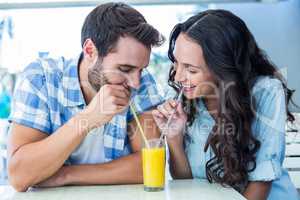 Cute couple drinking an orange juice together
