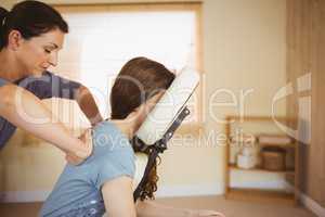 Young woman getting massage in chair