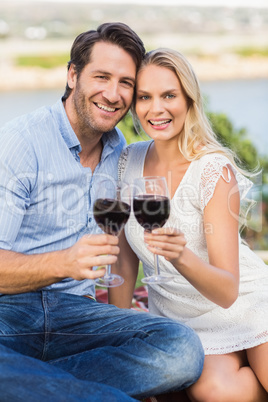 Cute couple on date holding red wine glasses