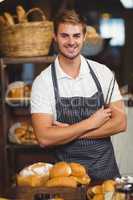 Handsome waiter with arms crossed