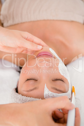 Attractive woman receiving treatment at spa center