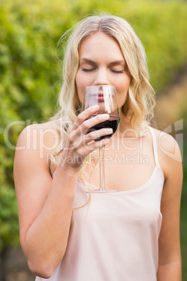 Young happy woman holding a glass of wine