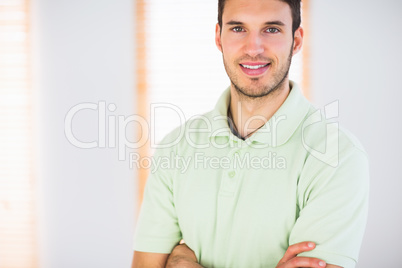Portrait of smiling handsome masseur with arms crossed