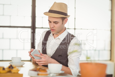 Concentrated hipster using smartphone