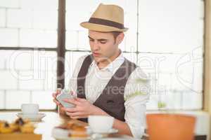 Concentrated hipster using smartphone