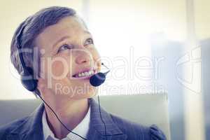 Smiling businesswoman phoning with headphone