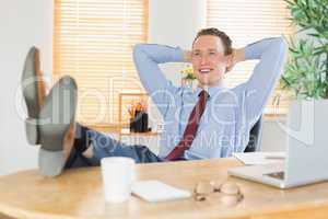 Relaxed businessman with his feet up