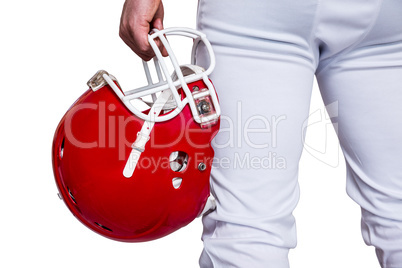 American football player holding a helmet