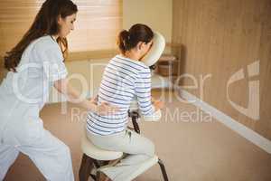 Young woman getting massage in chair