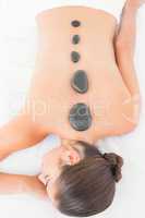 Pretty woman enjoying a hot stone massage