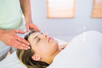 Relaxed pregnant woman enjoying head massage