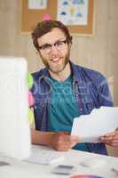 Happy hipster working at his desk