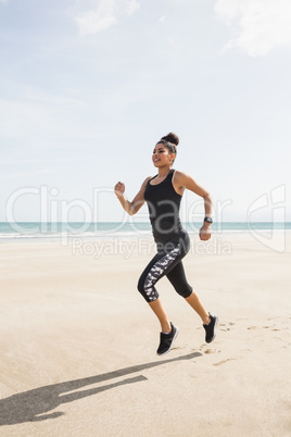 Fit woman jogging on the sand