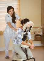 Young woman getting massage in chair