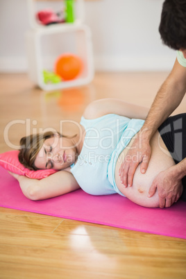 Pregnant woman getting massage for pregnant belly