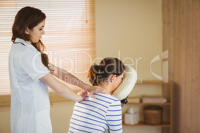 Young woman getting massage in chair