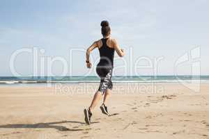 Fit woman jogging on the sand