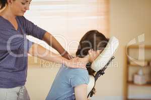 Young woman getting massage in chair