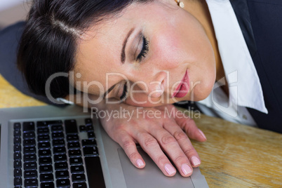 Businesswoman taking a nap on her desk