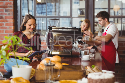 Handsome barista preparing a cup of coffee