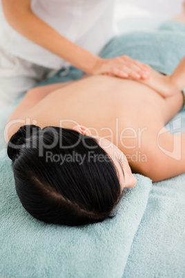 Attractive woman receiving back massage at spa center