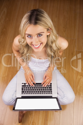 Portrait of a beautiful woman with laptop on her knee