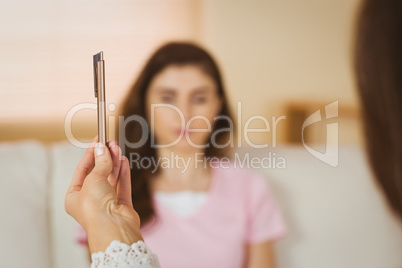 Hypnotherapist holding pen before her patient
