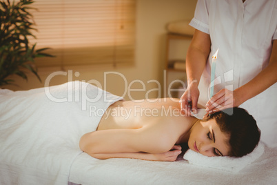 Young woman getting ear candling treatment