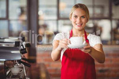 Pretty barista handing a cup of coffee