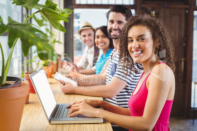 Happy friends using electronic devices