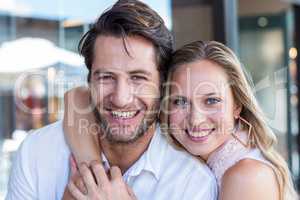 Smiling woman putting arm around her boyfriend