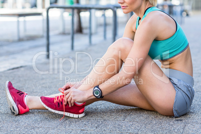 A beautiful woman tying her shoelaces