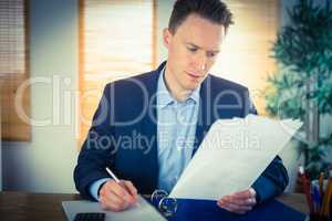 Concentrated businessman reading a document