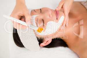 Attractive woman receiving treatment at spa center