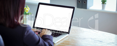 Businesswoman working at her desk on laptop