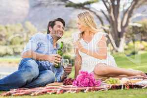 Cute couple on date holding glasses of wine