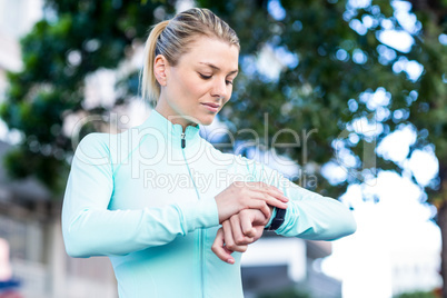 A beautiful athlete watching her watch