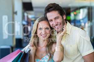 Smiling woman lovingly touching face of her boyfriend