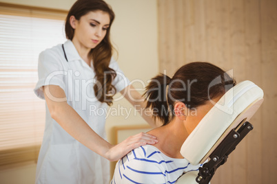 Young woman getting massage in chair