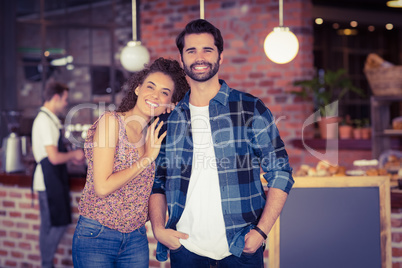 Smiling hipster couple in front of barista