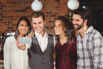 Smiling friends taking a selfie together